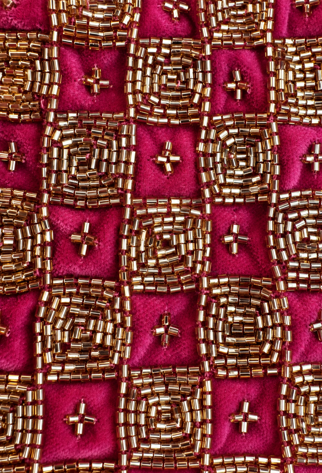 Fuchsia velvet fabric with dense gold beadwork and small gold bead accents