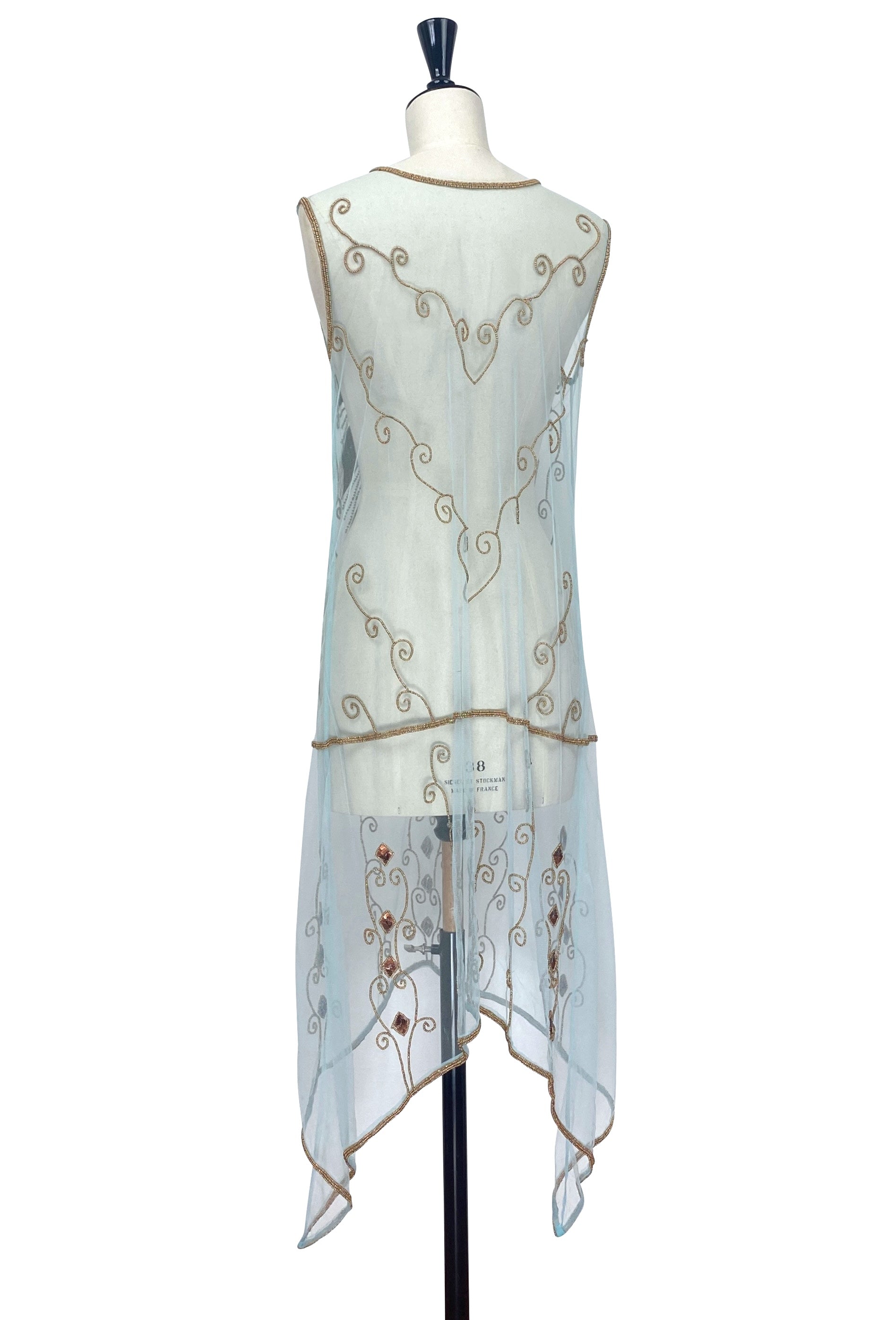 Sleeveless turquoise overlay dress, back view with ornate gold scrollwork and beaded trim