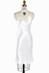 Ivory satin slip dress with V-neck and spaghetti straps, fitted bias cut, knee-length hem