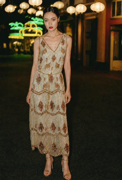 Gold beaded sleeveless midi gown with V-neck and tiered sequin fringe