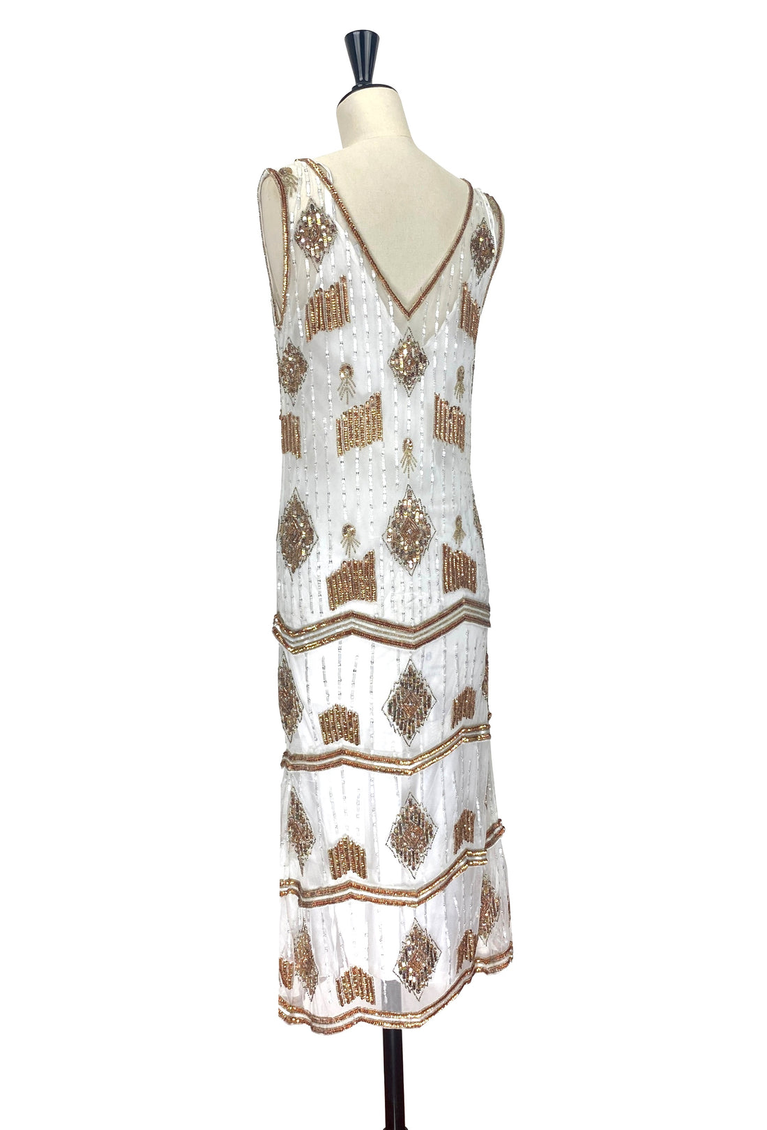 White sleeveless art deco gown with V-neck, gold beadwork and tiered geometric stripes