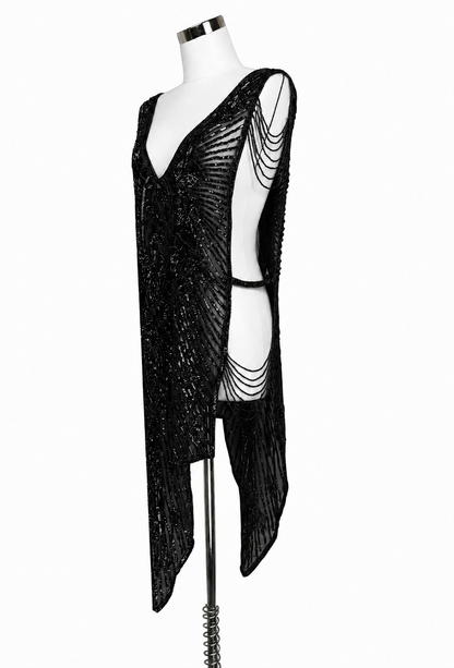 Black sequin overlay gown with one-shoulder drape and chain-like side chains