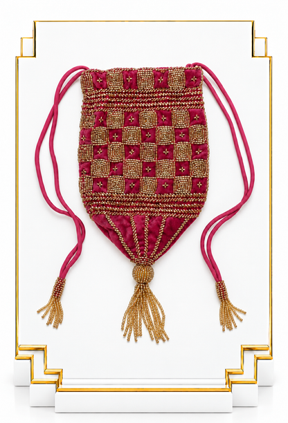 Fuchsia velvet pouch with gold checkered beadwork, drawstring cords, and tassels