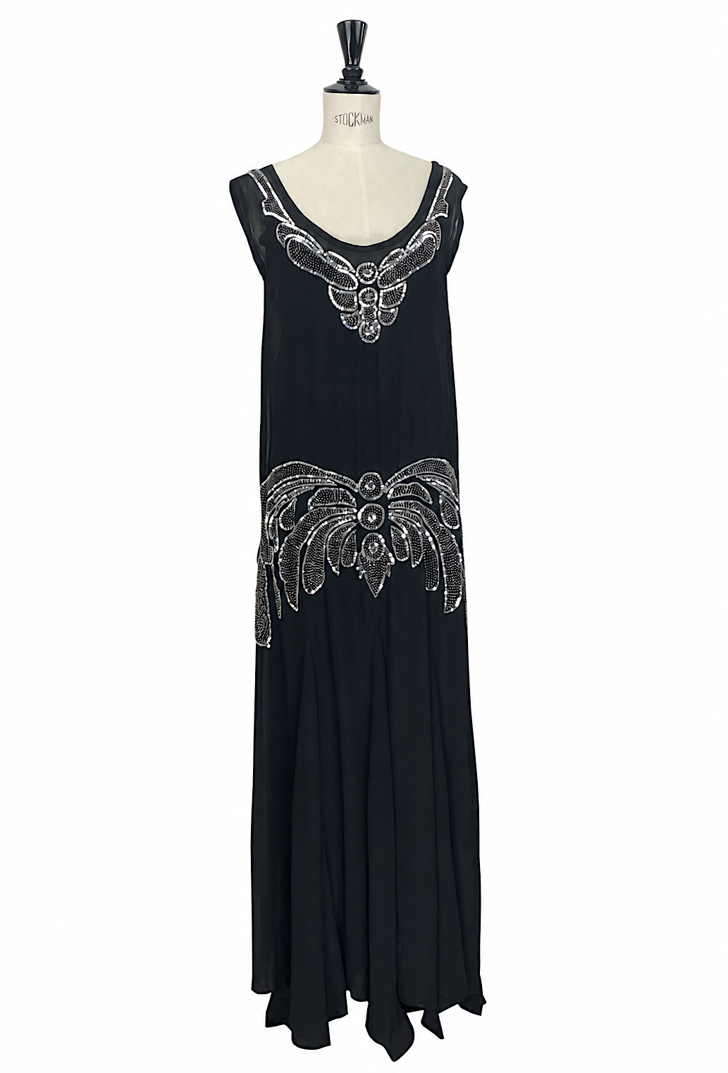 Black sleeveless evening gown with silver filigree embroidery at neckline and hem
