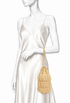Small golden tassel pochette with fringe tiers and braided wrist strap