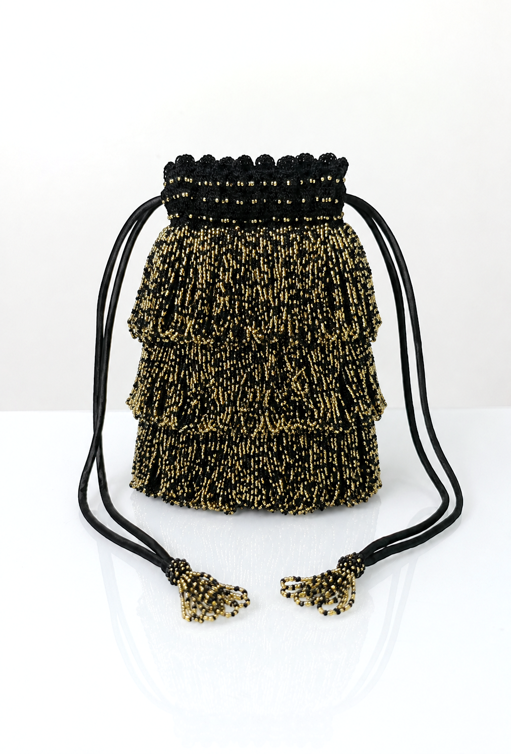 Gold and black beaded drawstring pochette bag with tassel cord ends