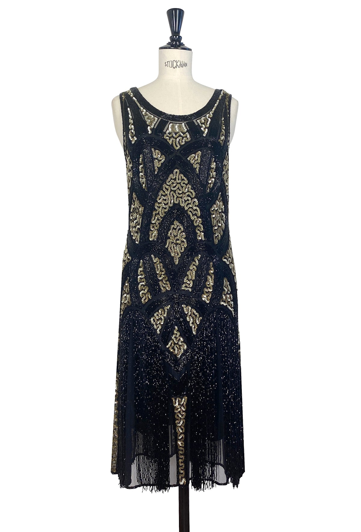 Black and gold sequin sleeveless dress with ornate pattern and fringe hem