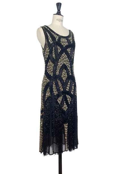 Black sleeveless sequin mini dress with gold filigree design and sheer fringe