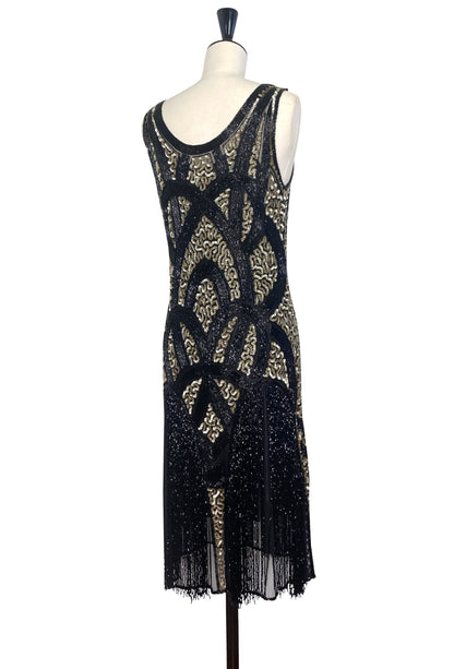 Black and gold sequin sleeveless dress with decorative front panel and fringe