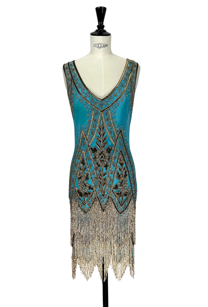 Sleeveless teal beaded gown with gold geometric neckline and long fringe hem