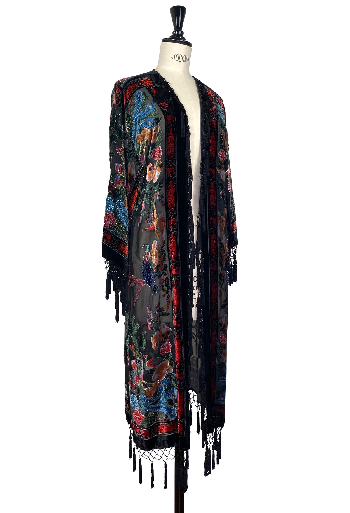 Embroidered floral kimono with long tassel fringe, side view on black base with blue-red motifs