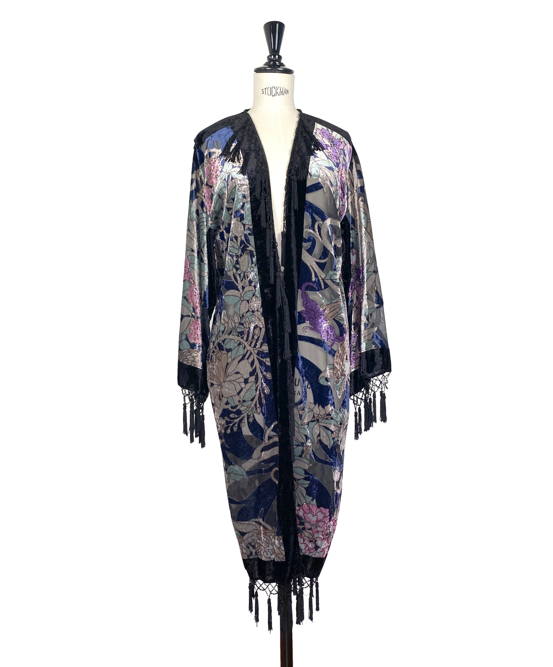Velvet kimono with dark base, ornate floral face print, open front, fringe trim