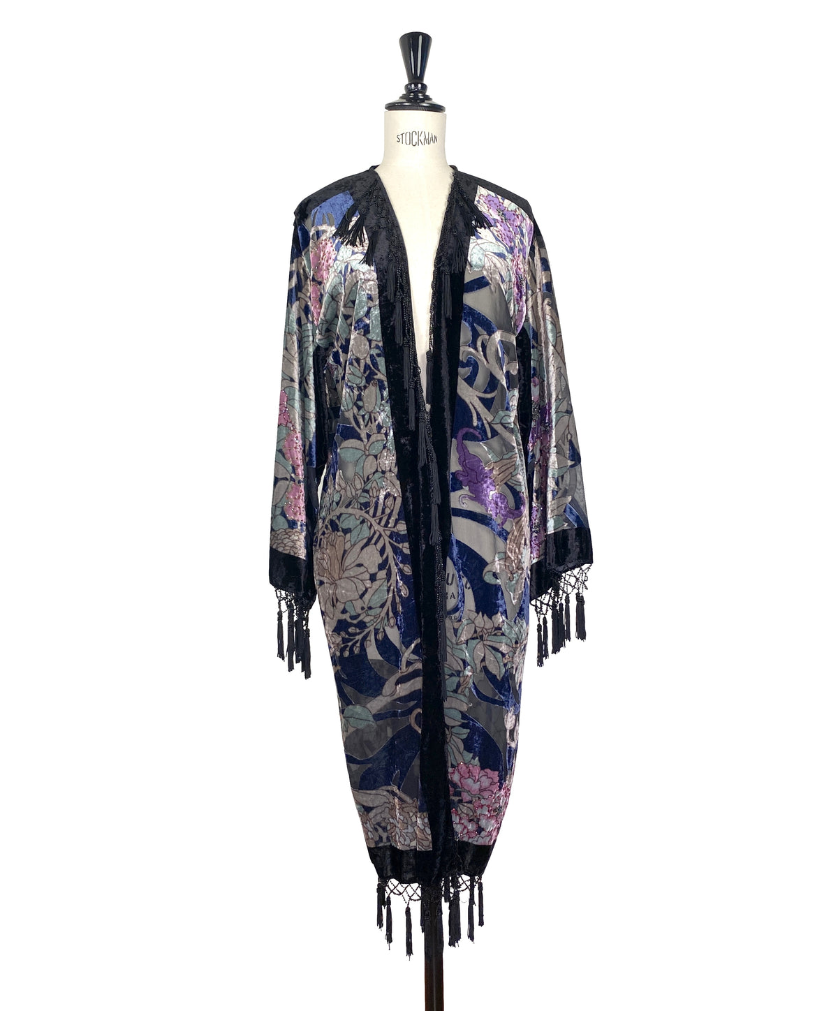 Velvet kimono with dark base, ornate floral face print, open front, fringe trim