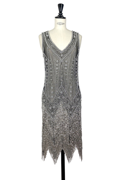 Embellished sleeveless V-neck evening gown with silver-toned beading and fringe hem.