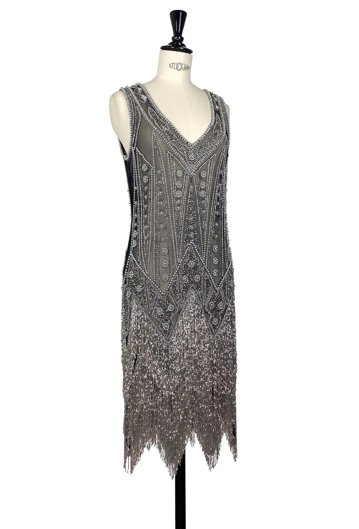 Silver beaded sleeveless gown with V-neck and decorative medallion pattern, fringed.