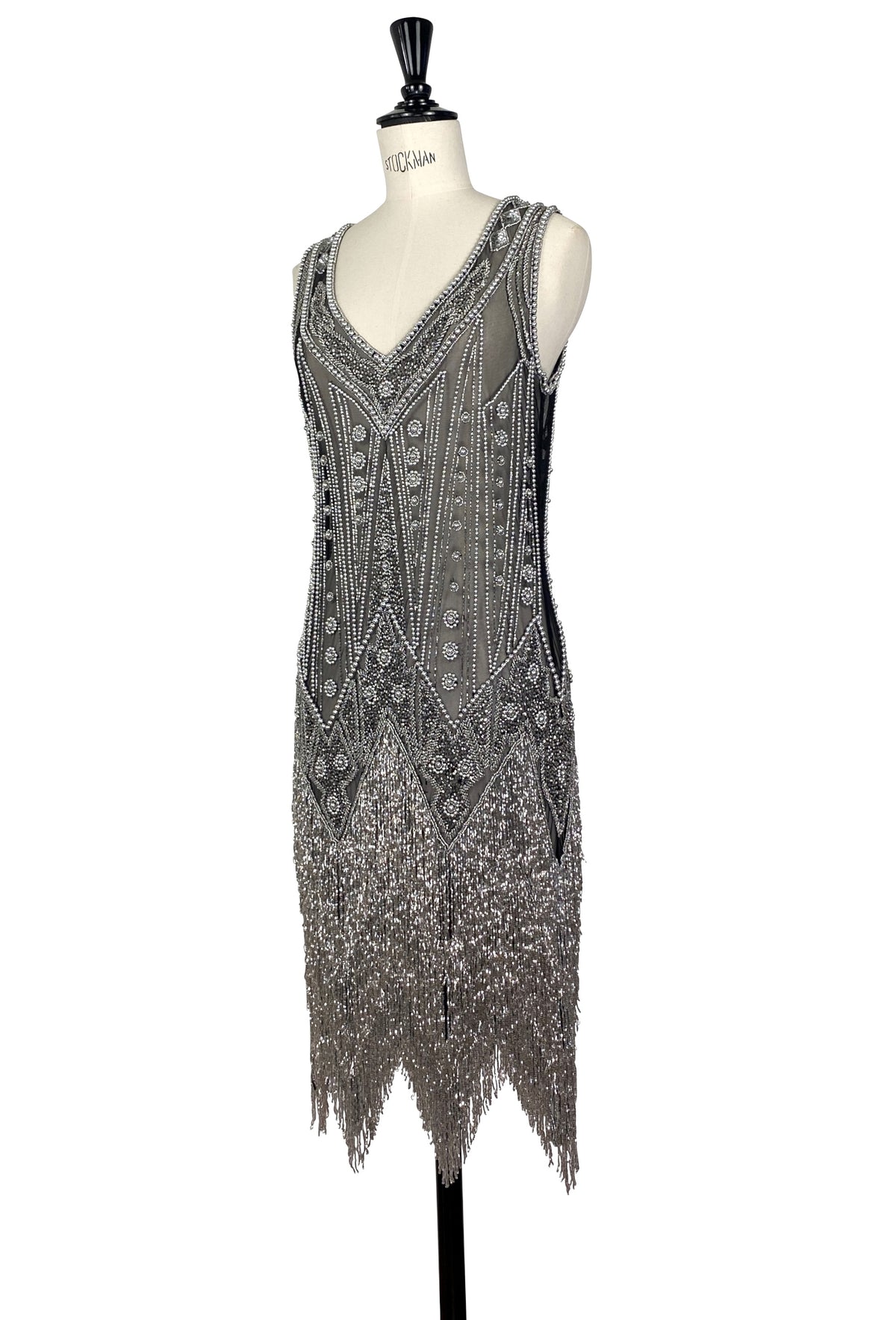 Sleeveless V-neck beaded gown with vertical motif details and fringe at the hem.