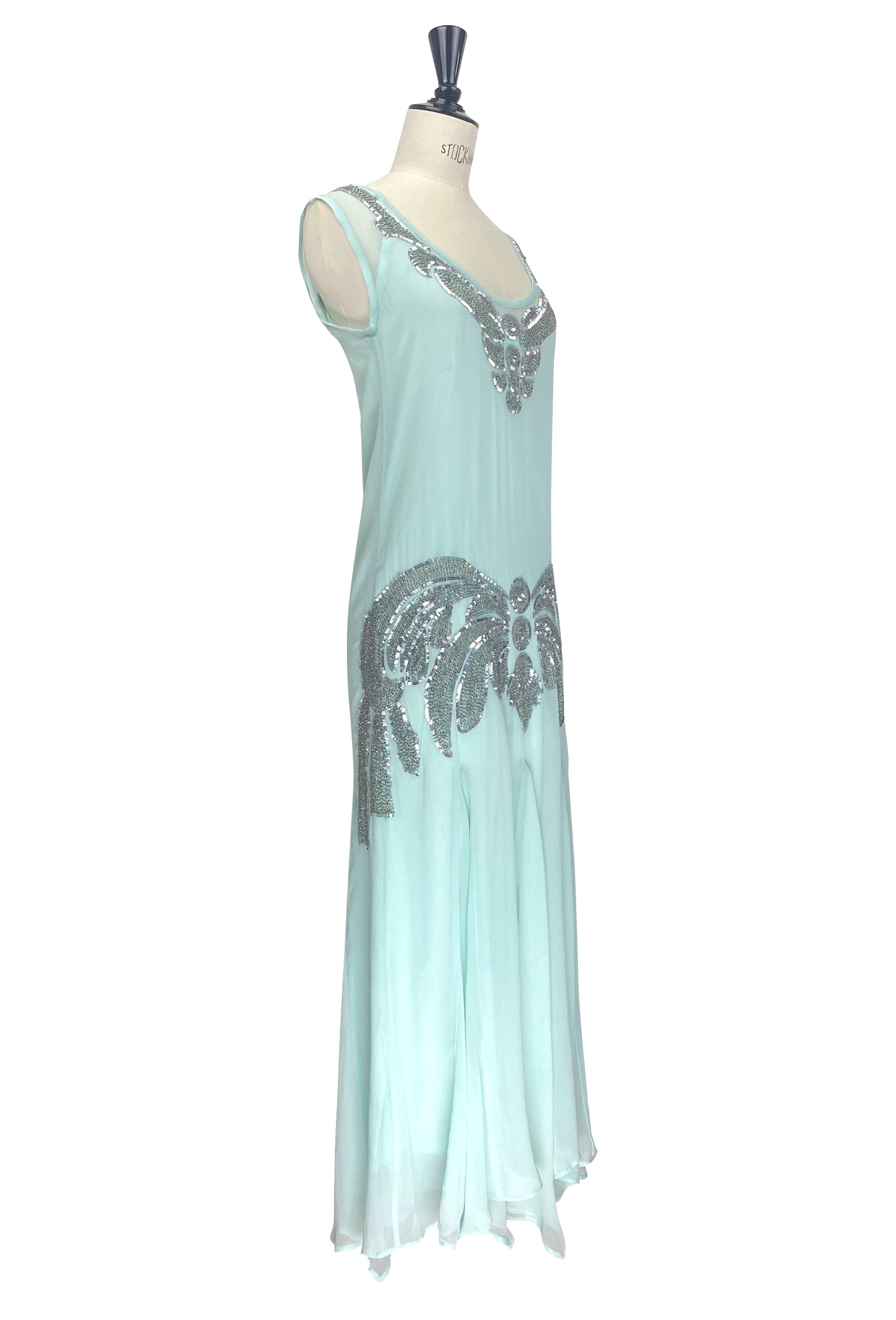Aqua sleeveless chiffon gown with silver beaded trim and vertical motif detail, side view.