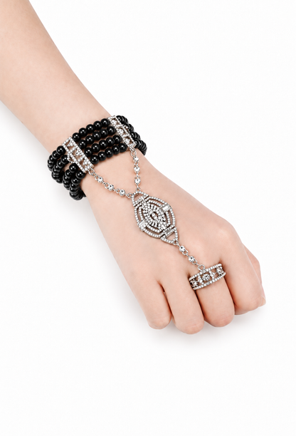Noir pearl hand jewel worn: black bead cuff with crystal center pendant and dangling chains