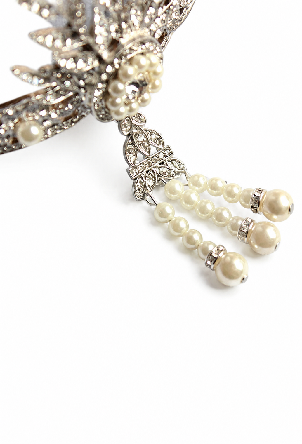 Close-up of silver tiara end with pearl strands and gold-toned bead tips
