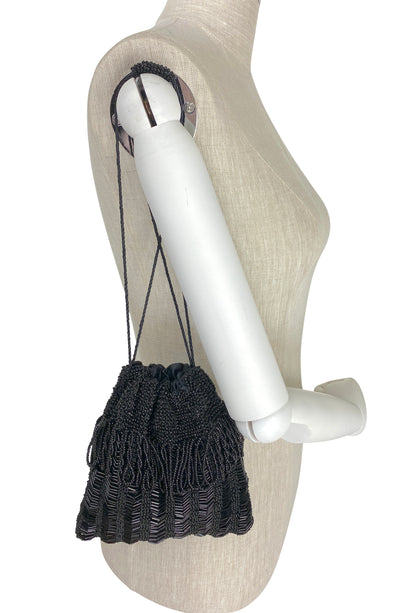 Black knit drawstring mini pouch with braided cord drawstrings