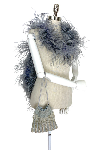 Light blue knit drawstring mini pouch with braided cord drawstring and tassel