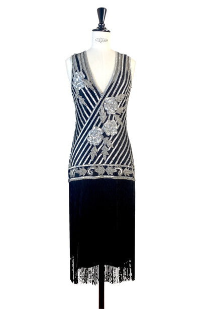 Silver beaded V-neck gown with diagonal stripe pattern, decorative buttons, fringe bottom