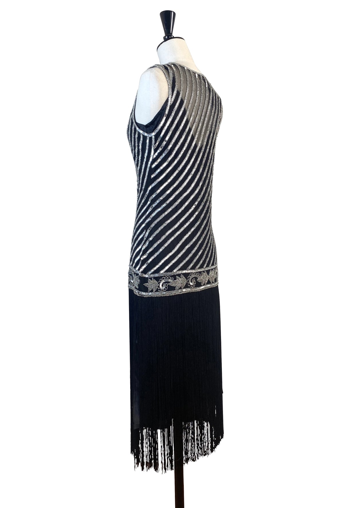 Silver beaded art deco gown with striped sequin panel and fringe hem over dark base