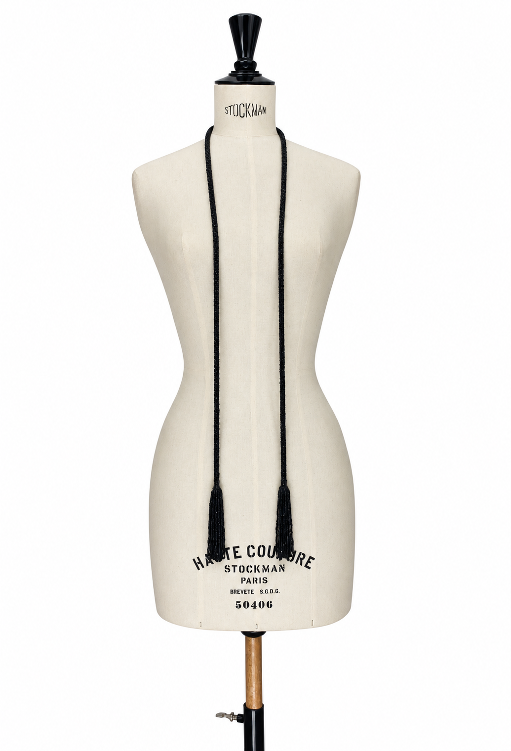 Black tassel lariat necklace with braided cord drape on mannequin