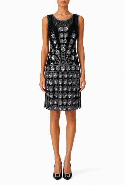 Black sleeveless cocktail dress with rhinestone embellishment and flared beaded skirt
