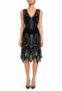 Sleeveless V-neck mini dress on model, geometric beading with fringe