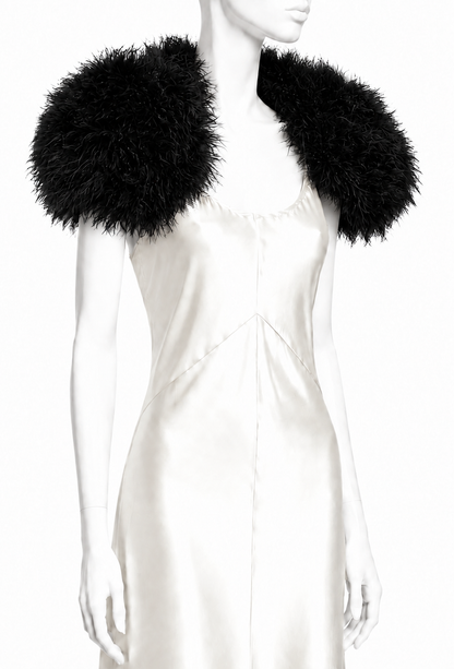Black feather shoulderette with voluminous puff sleeves over white dress