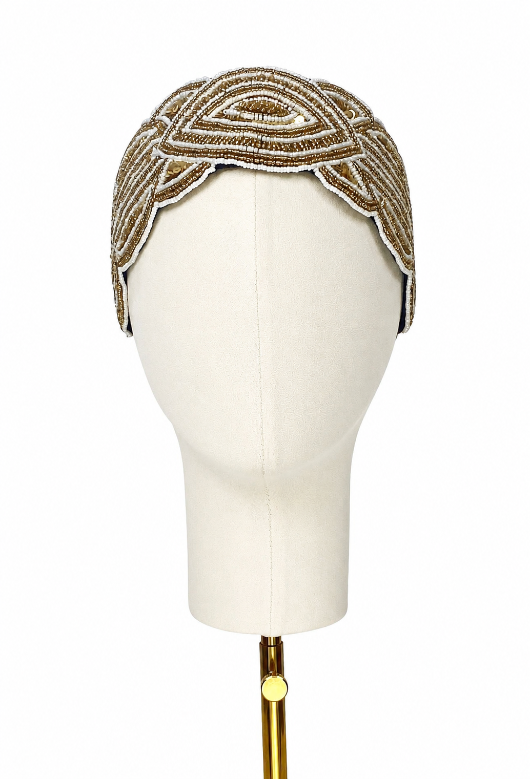 Embellished silk bandeau with gold-tone geometric trim, curved crown design on mannequin