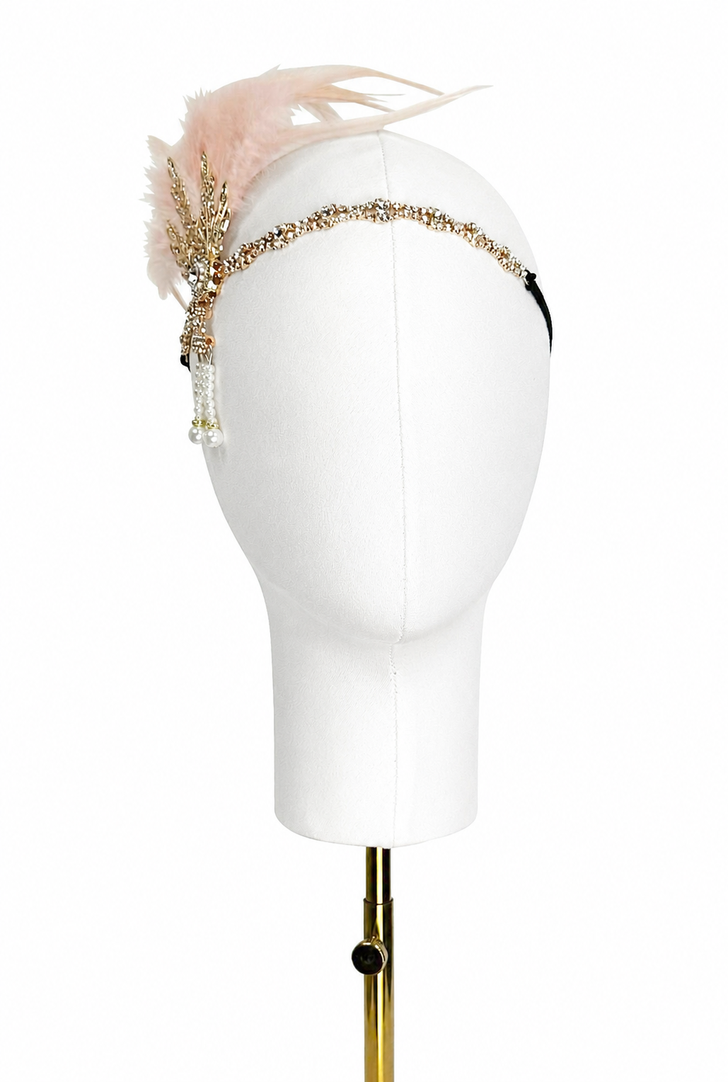 Blush feather headband with gold-tone rhinestone band and dangling tassel