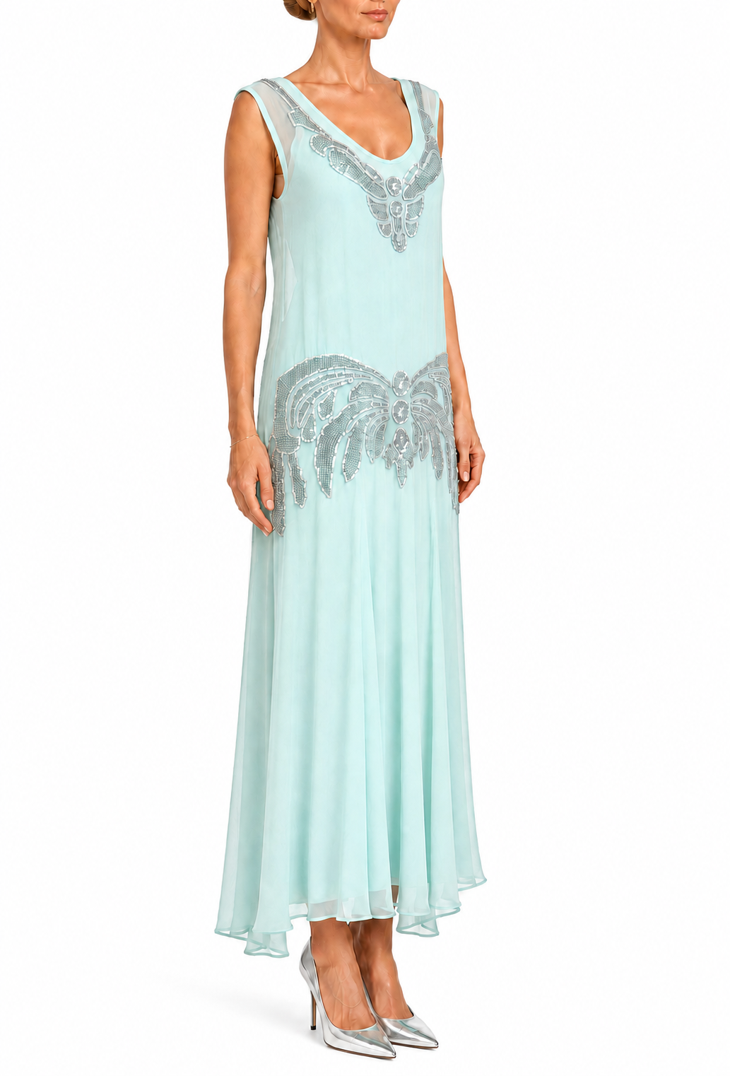 Aqua sleeveless chiffon gown with silver beaded V-neck and ornate hem, worn with heels.
