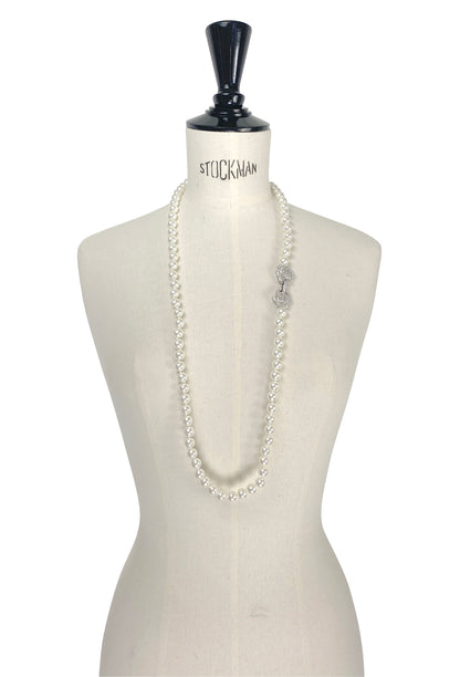 Long double-strand pearl necklace with bead-like pearls, draped on a mannequin