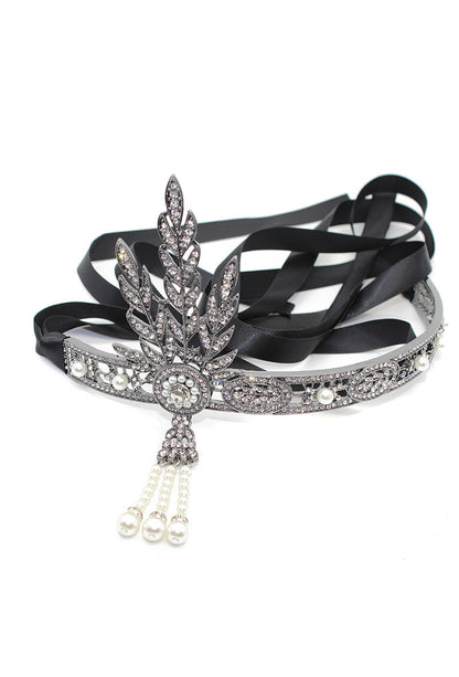 Rhinestone tiara with central leaf design, dangling bead drops, and black ribbon band